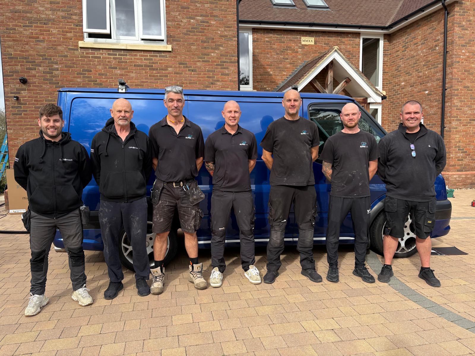 The Alpha HVAC team together beside their blue van